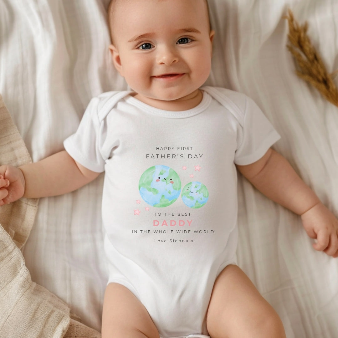 personalised sleepsuit celebrating first father's day, featuring a cute planet design.